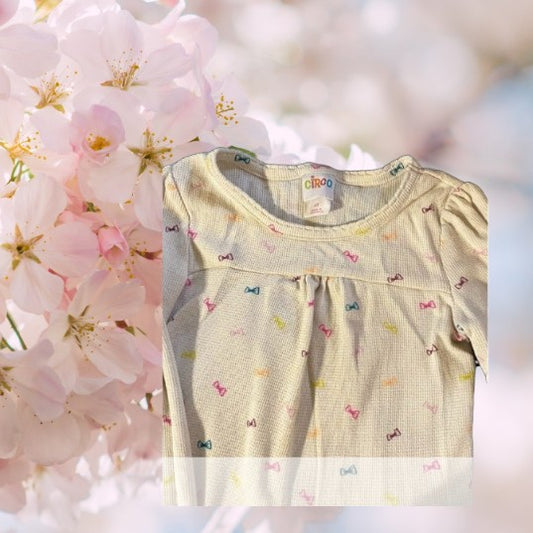 Circo Pattern Design Top features vibrant, multicolored bows throughout the design