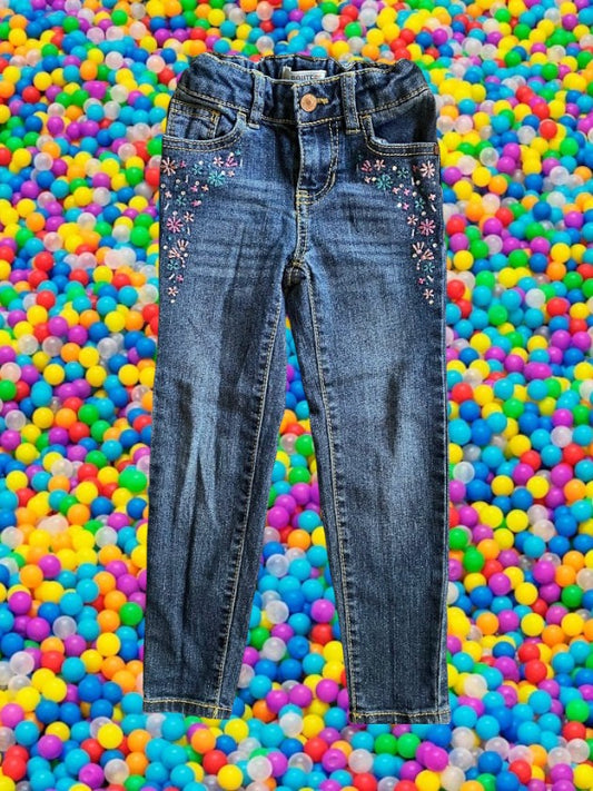 Route 66 distressed floral rhinestone skinny jeans provide a polished and stylish design