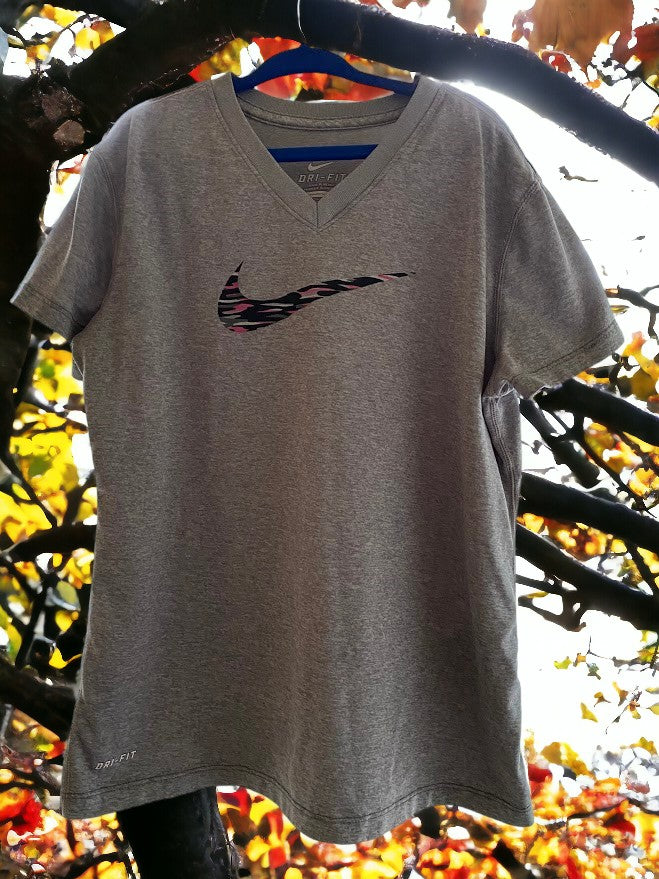 The Nike Dri-Fit V-Neck Top with vibrant logo colors