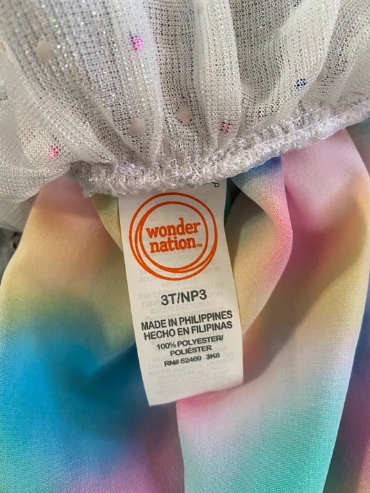 The Wonder Nation colorful reversible skirt features vibrant rainbow colors on one side and mesh with metallic dot designs on the other