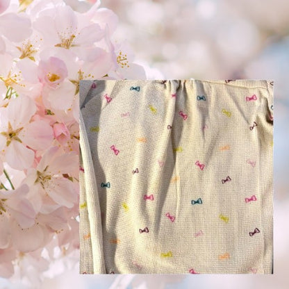 Circo Pattern Design Top features vibrant, multicolored bows throughout the design