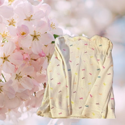 Circo Pattern Design Top features vibrant, multicolored bows throughout the design