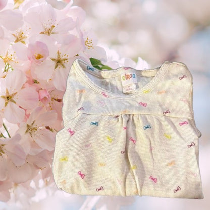 Circo Pattern Design Top features vibrant, multicolored bows throughout the design