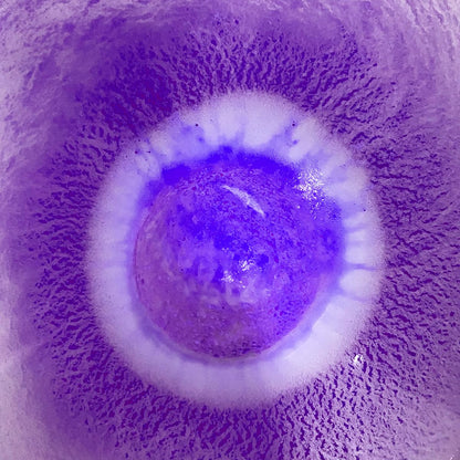 Microscopic view of a virus particle with a purple background
