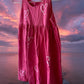 This girl's pink dress features a sleeveless design with a heart pattern making it a perfect dress for summer
