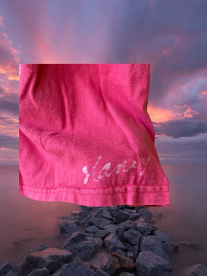 This girl's pink dress features a sleeveless design with a heart pattern making it a perfect dress for summer