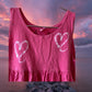 This girl's pink dress features a sleeveless design with a heart pattern making it a perfect dress for summer