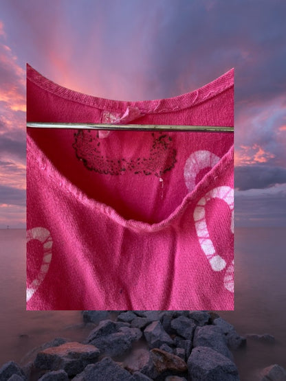 This girl's pink dress features a sleeveless design with a heart pattern making it a perfect dress for summer