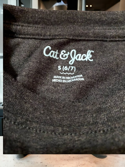 Black graphic tee featuring a pattern of inspirational sayings