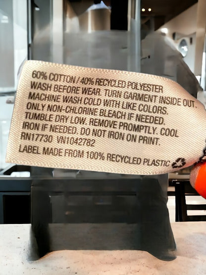 Black graphic tee featuring a pattern of inspirational sayings