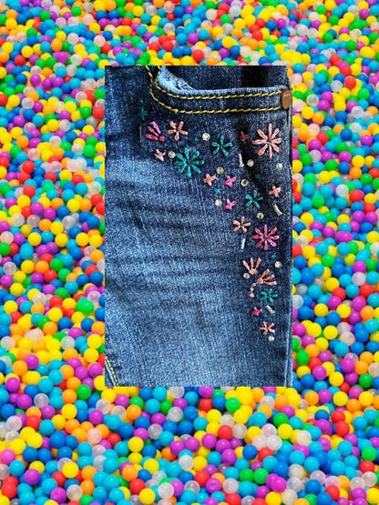 Route 66 distressed floral rhinestone skinny jeans provide a polished and stylish design