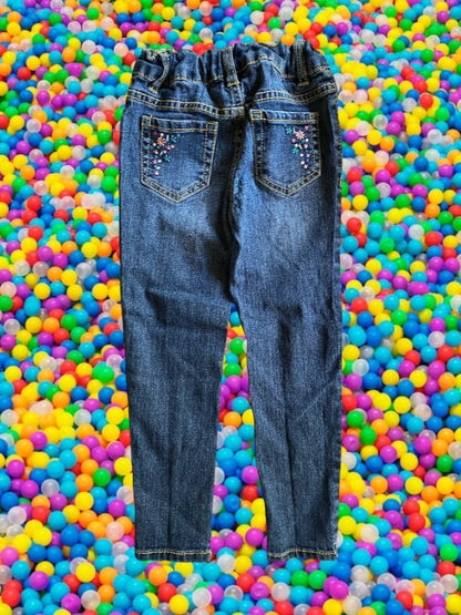 Route 66 distressed floral rhinestone skinny jeans provide a polished and stylish design