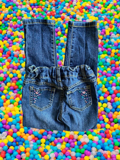 Route 66 distressed floral rhinestone skinny jeans provide a polished and stylish design