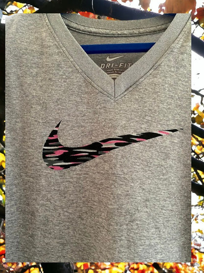The Nike Dri-Fit V-Neck Top with vibrant logo colors