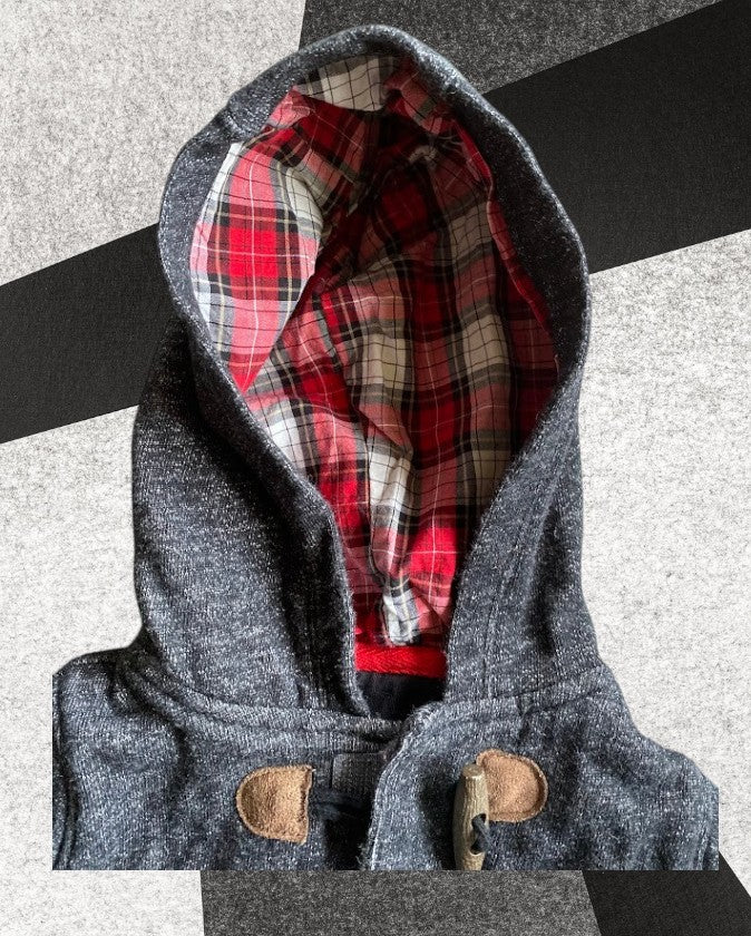 Baby sweater featuring a plaid lined hoodie with wooden toggle buttons