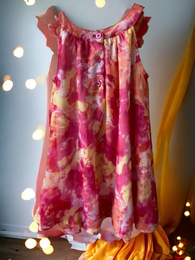 This sleeveless dress features a colorful floral design