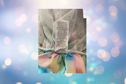 The Wonder Nation colorful reversible skirt features vibrant rainbow colors on one side and mesh with metallic dot designs on the other