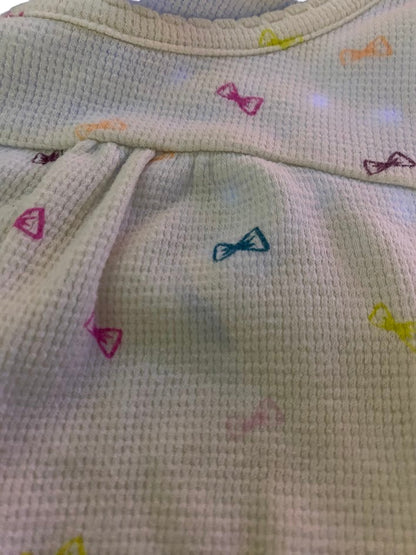 Circo Pattern Design Top features vibrant, multicolored bows throughout the design