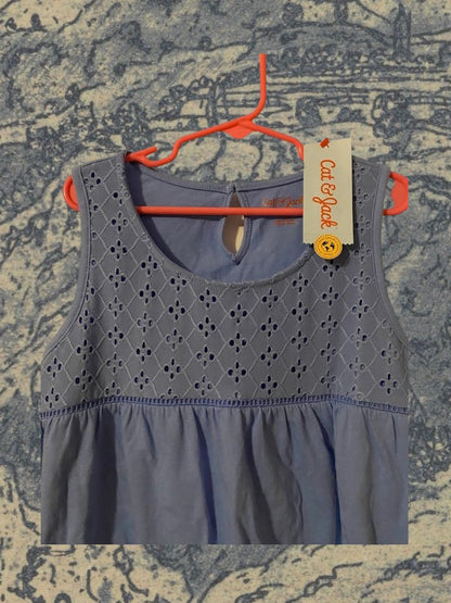 Sleeveless yoke tank top fitted on top and flowy on the bottom