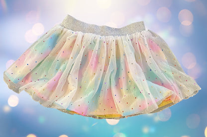 The Wonder Nation colorful reversible skirt features vibrant rainbow colors on one side and mesh with metallic dot designs on the other