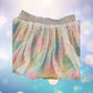 The Wonder Nation colorful reversible skirt features vibrant rainbow colors on one side and mesh with metallic dot designs on the other
