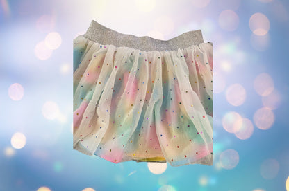 The Wonder Nation colorful reversible skirt features vibrant rainbow colors on one side and mesh with metallic dot designs on the other