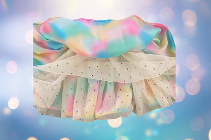 The Wonder Nation colorful reversible skirt features vibrant rainbow colors on one side and mesh with metallic dot designs on the other