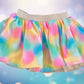The Wonder Nation colorful reversible skirt features vibrant rainbow colors on one side and mesh with metallic dot designs on the other