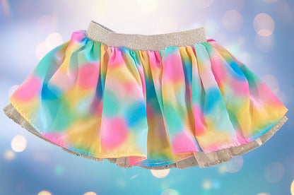 The Wonder Nation colorful reversible skirt features vibrant rainbow colors on one side and mesh with metallic dot designs on the other